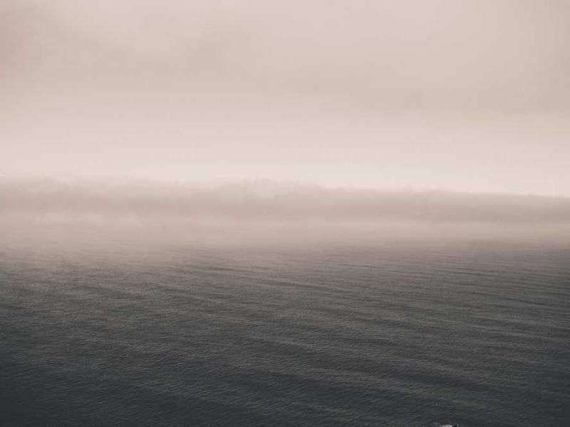 A trekker looking at a map in the mountains