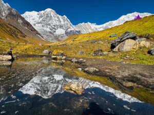 the view of Annapurna south seen from Machhapuchhre Base Camp in sunny day with water reflexon.