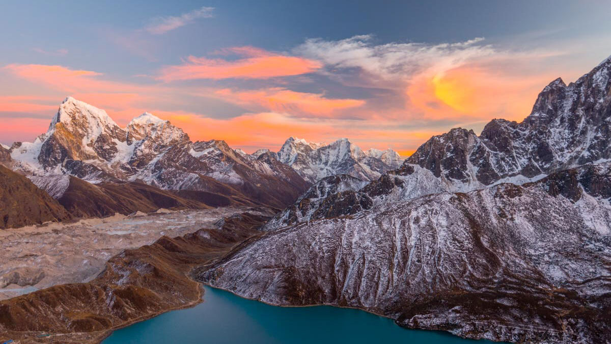 Sunrise from gokyo lake. Gokyo lake in the middle mountain range around.