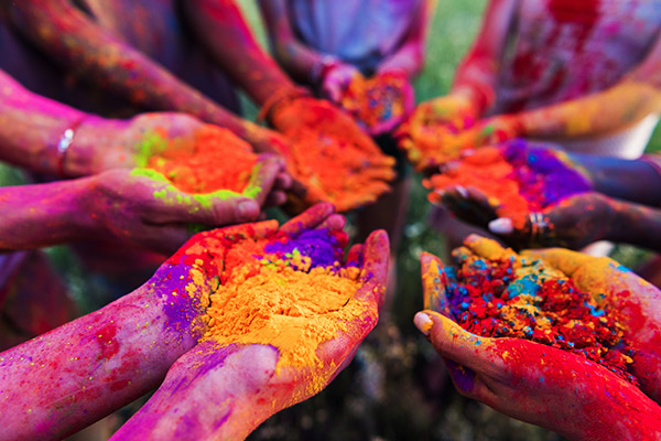 People's hand full oof different colour during holi