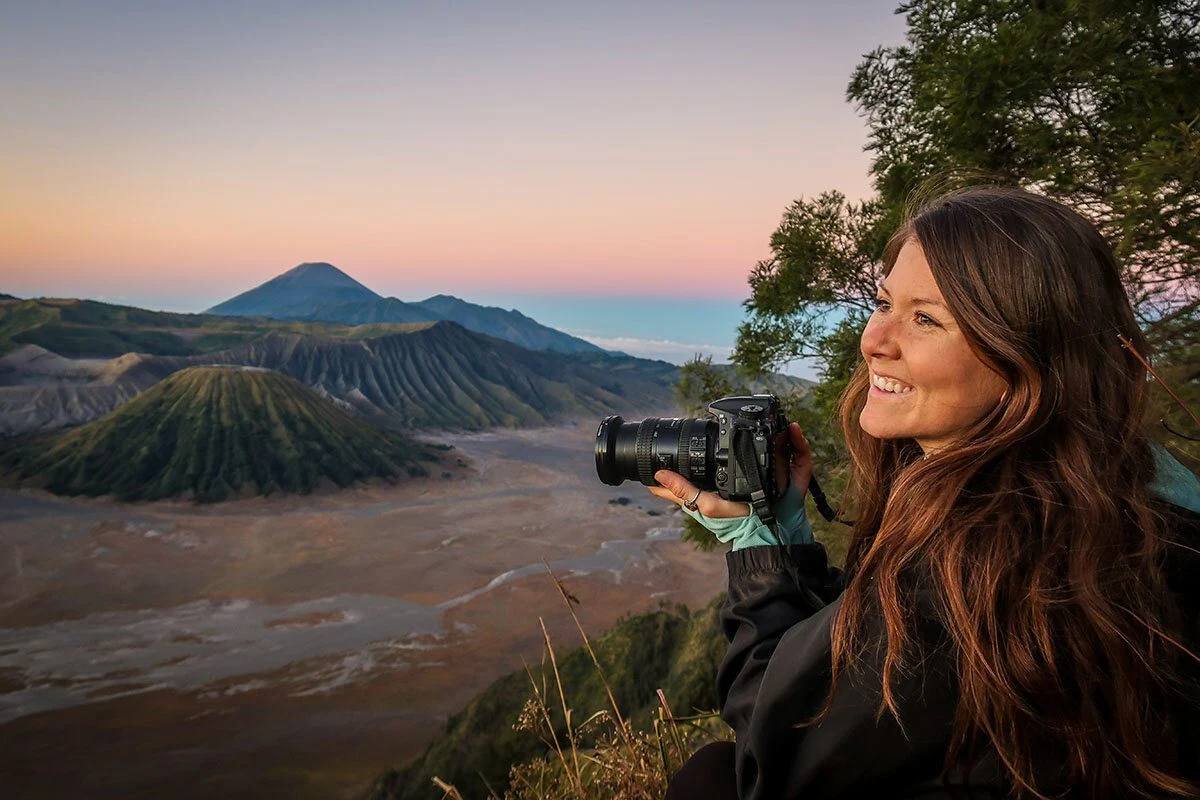 women with dslr on hands taking pictures