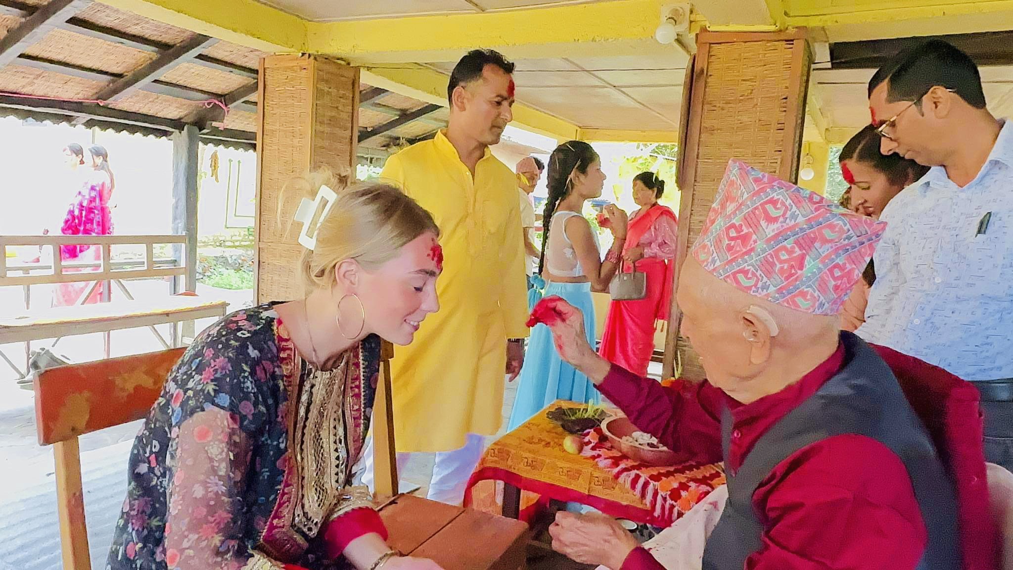 Foreigners celebrating Dashain and receiving blessing from Nepali